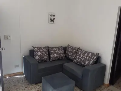 a blue couch with pillows in a living room at Apartment #21 at Waterfront Playa Alicia in Sosúa