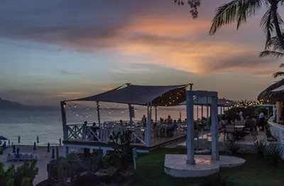 a wedding reception at the beach at dusk at Bungalow #9 at Waterfront Playa Alicia in Sosúa