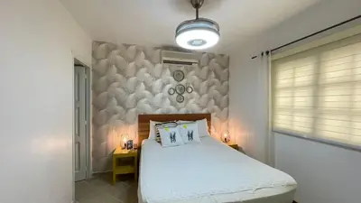 a bedroom with a bed with two pillows on it at Playa Turquesa only 50m From the Beach Walk to all Restaurants in Las Terrenas
