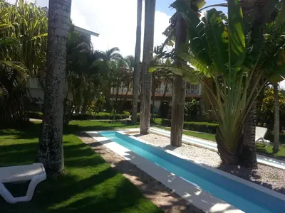 a pool in front of a house with palm trees at Playa Turquesa only 50m From the Beach Walk to all Restaurants in Las Terrenas