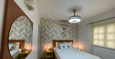 a bedroom with two beds and a mirror at Playa Turquesa only 50m From the Beach Walk to all Restaurants in Las Terrenas