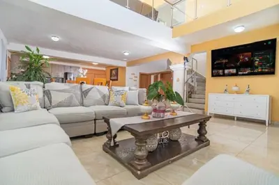 a living room with a couch and a table at Villa Nilsa ( The Blue House ) in Baní