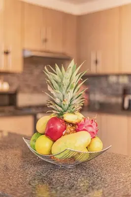 a bowl of fruit on a counter in a kitchen at Villa Nilsa ( The Blue House ) in Baní