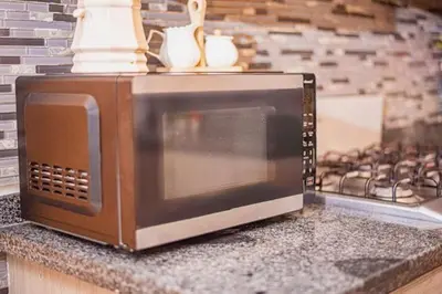 a microwave sitting on a counter next to a stove at Villa Nilsa ( The Blue House ) in Baní