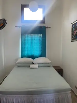 a bed with a blue headboard in a room at Ocean Breeze Villa Carismar in Cabrera