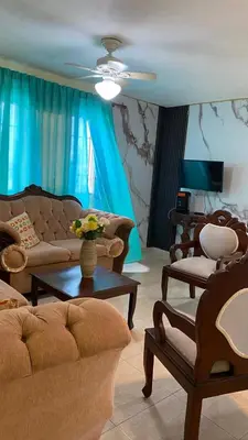 a living room with couches and chairs and a table at TriRoom Apartment SANTO DOMINGO ESTE in Santo Domingo