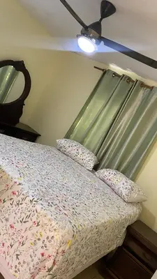 a bedroom with a bed with a ceiling fan at TriRoom Apartment SANTO DOMINGO ESTE in Santo Domingo