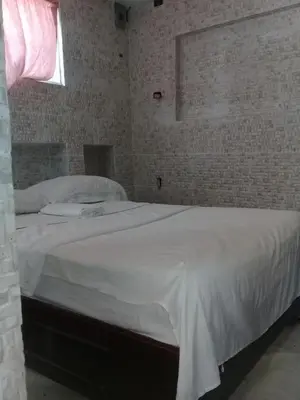 a bedroom with a large white bed with a window at Villa Julirous Rd 2 bedrooms apartment in Boca Chica
