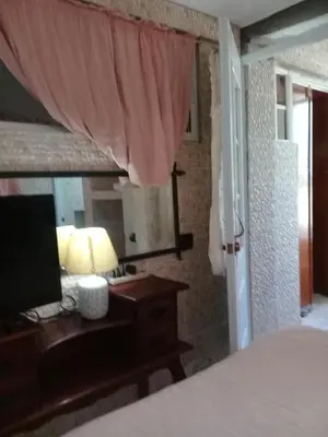 a bedroom with a bed and a desk with a lamp at Villa Julirous Rd 2 bedrooms apartment in Boca Chica