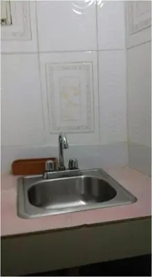 a sink in a kitchen with a pink counter top at Villa Julirous Rd 2 bedrooms apartment in Boca Chica