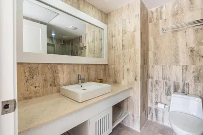 a bathroom with a sink and a mirror and a toilet at Newly Added El Portillo 2BR Apt in Abra Grande