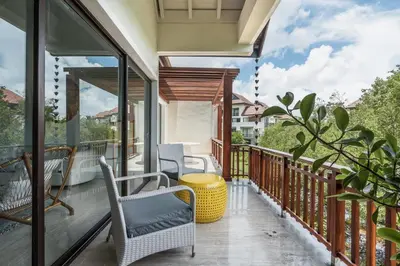 a balcony with chairs and a view of a building at Newly Added El Portillo 2BR Apt in Abra Grande