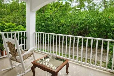 a porch with a rocking chair and a coffee table at Sol Dominicus 1 Apartamento con Cocina Solo Adultos in La Laguna