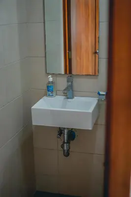 a bathroom with a white sink and a mirror at ARMONIA 408 APARTMENT IN GAZCUE in Santo Domingo
