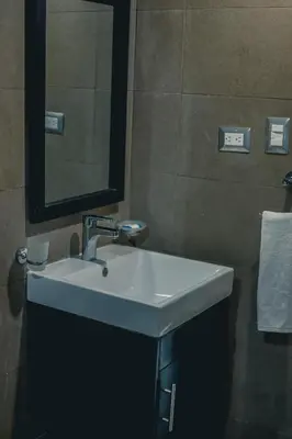 a bathroom with a white sink and a mirror at ARMONIA 408 APARTMENT IN GAZCUE in Santo Domingo