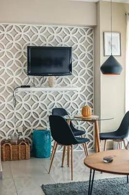 a living room with a tv on a wall at ARMONIA 408 APARTMENT IN GAZCUE in Santo Domingo