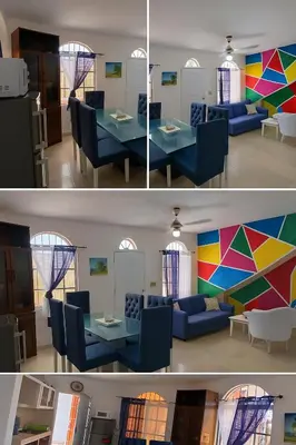 a living room and a dining room with a table at Villa Boutique con Piscina Privada a Minutos del Aeropuerto SDQ in Boca Chica