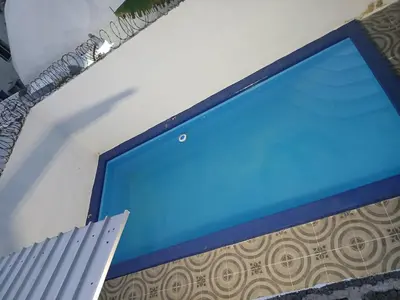 a blue computer screen on a wall at Villa Boutique con Piscina Privada a Minutos del Aeropuerto SDQ in Boca Chica