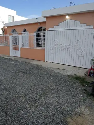a white fence in front of a building at Villa Boutique con Piscina Privada a Minutos del Aeropuerto SDQ in Boca Chica