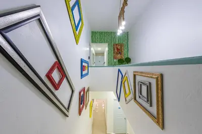 a hallway with paintings on the walls of a room at Bamboo Hoouse in Santo Domingo