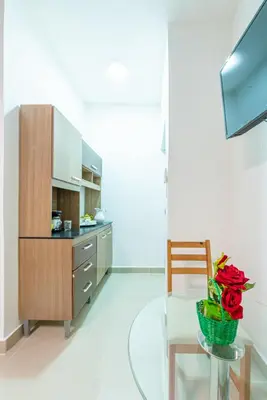 a kitchen with a glass table and a wooden cabinet at Bamboo Hoouse in Santo Domingo
