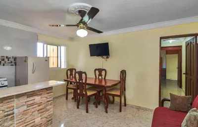 a kitchen and dining room with a table and chairs at 2 Bedroom-Apartment - Corales del Sur Ole Las Americas- Isabelita - Aeropuerto in La Viva