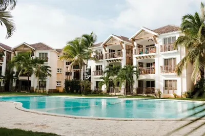 a resort with a swimming pool and palm trees at Punta Cana 2 Bedr. up to 6 guests 1 mile to Beach in Punta Cana