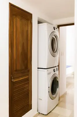 a laundry room with a washer and dryer next to a door at Punta Cana 2 Bedr. up to 6 guests 1 mile to Beach in Punta Cana