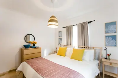a bedroom with a bed with yellow pillows at Punta Cana 2 Bedr. up to 6 guests 1 mile to Beach in Punta Cana