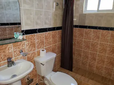 a bathroom with a toilet and a sink at Costambar Beach Seaside Apartment in San Felipe de Puerto Plata