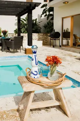 a table with a vase on it next to a pool at Ocean View Villa/Luxury Puerto Bahia Resort/Samaná in Santa Bárbara de Samaná