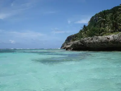a beach with turquoise water and palm trees at Palm-covered house in the tropical -Casa Oli in Las Galeras
