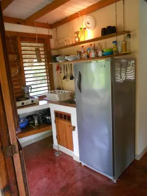 a kitchen with a stainless steel refrigerator in it at Palm-covered house in the tropical -Casa Oli in Las Galeras