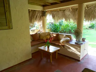 a living room with a couch and a table at Palm-covered house in the tropical -Casa Oli in Las Galeras