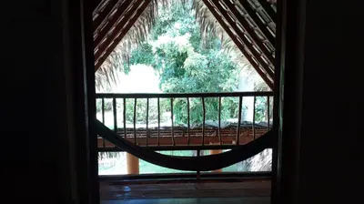 a window with a hammock in a room at Casa 3 amigos-Palm roofed house in Las Galeras
