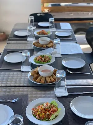 a long table with plates of food on it at Altos de la Caobita in Barreras