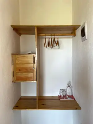 a kitchen with a wooden shelf with hangers at Altos de la Caobita in Barreras