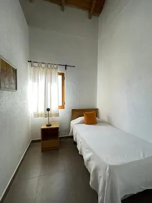 two twin beds in a room with a window at Altos de la Caobita in Barreras