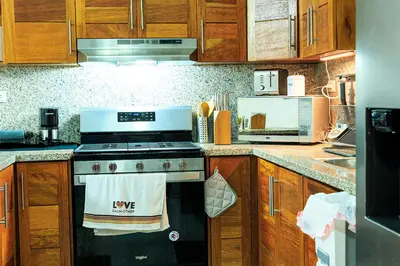 a kitchen with a stove with a towel on the oven at Self-checking-Fast internet-Alexa-Smart-Tv-AC-Hot Water in Ensanche Ozama