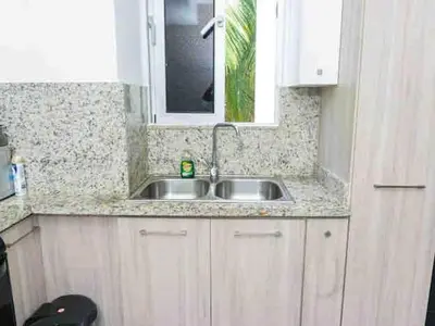 a kitchen counter with a sink and a window at Cozy Apartment near Downtown Center in Santo Domingo