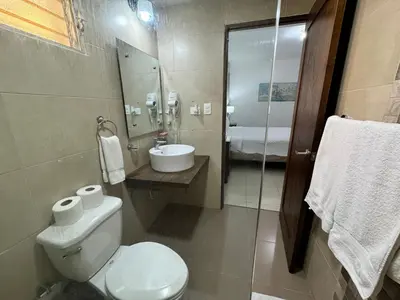 a bathroom with a toilet and a sink at Paramount 3-Bedroom Apartment with Parking in San Felipe de Puerto Plata