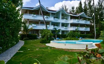 a large building with two swimming pools in front of it at Hotel Residence Marilar in Las Terrenas