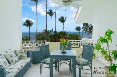 a living room with a couch and a table and chairs at Hotel Residence Marilar in Las Terrenas