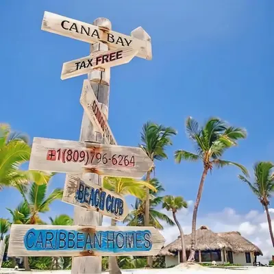 a street sign on a beach with palm trees at Cana Rock Star Pool View Whith BBQ in Punta Cana