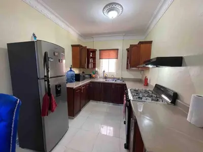a kitchen with a stainless steel refrigerator and a sink at Entire Apartment Tu Nido De Amor netflix Wifi in Santo Domingo