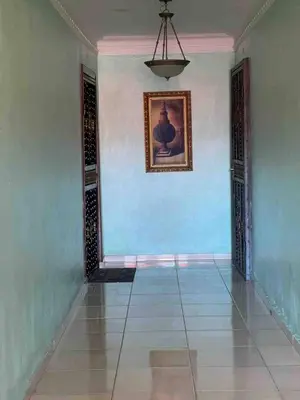 a hallway with blue walls and a painting on the wall at Entire Apartment Tu Nido De Amor netflix Wifi in Santo Domingo