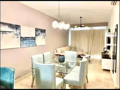 a dining room with a glass table and chairs at Cana Rock Chic Golf de Lux in Punta Cana