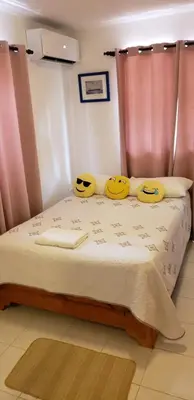 a bedroom with a bed with two smiley faces on it at Lovely location , right downtown Puerto Plata in San Felipe de Puerto Plata