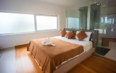 a bedroom with a bed with a stuffed animal on it at Villas Agua Dulce in Sosúa
