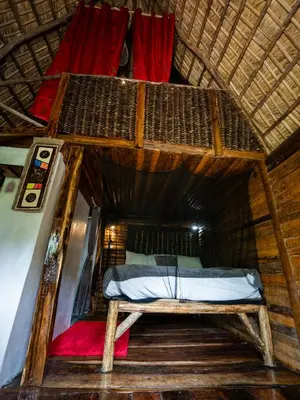 an attic bedroom with a bed in a room at Valle Bucana in Santa Bárbara de Samaná
